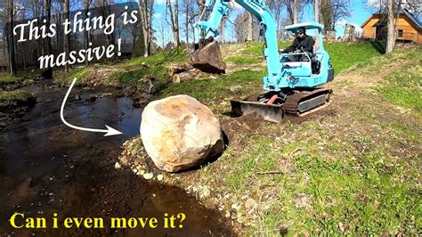 compact rock with excavator|Moving a big boulder with a mini excavator .